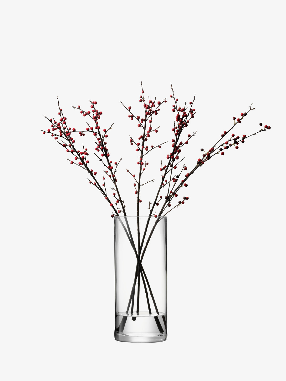 Clear, mouth-blown cylindrical lsa-international vase containing several branches with red berries.