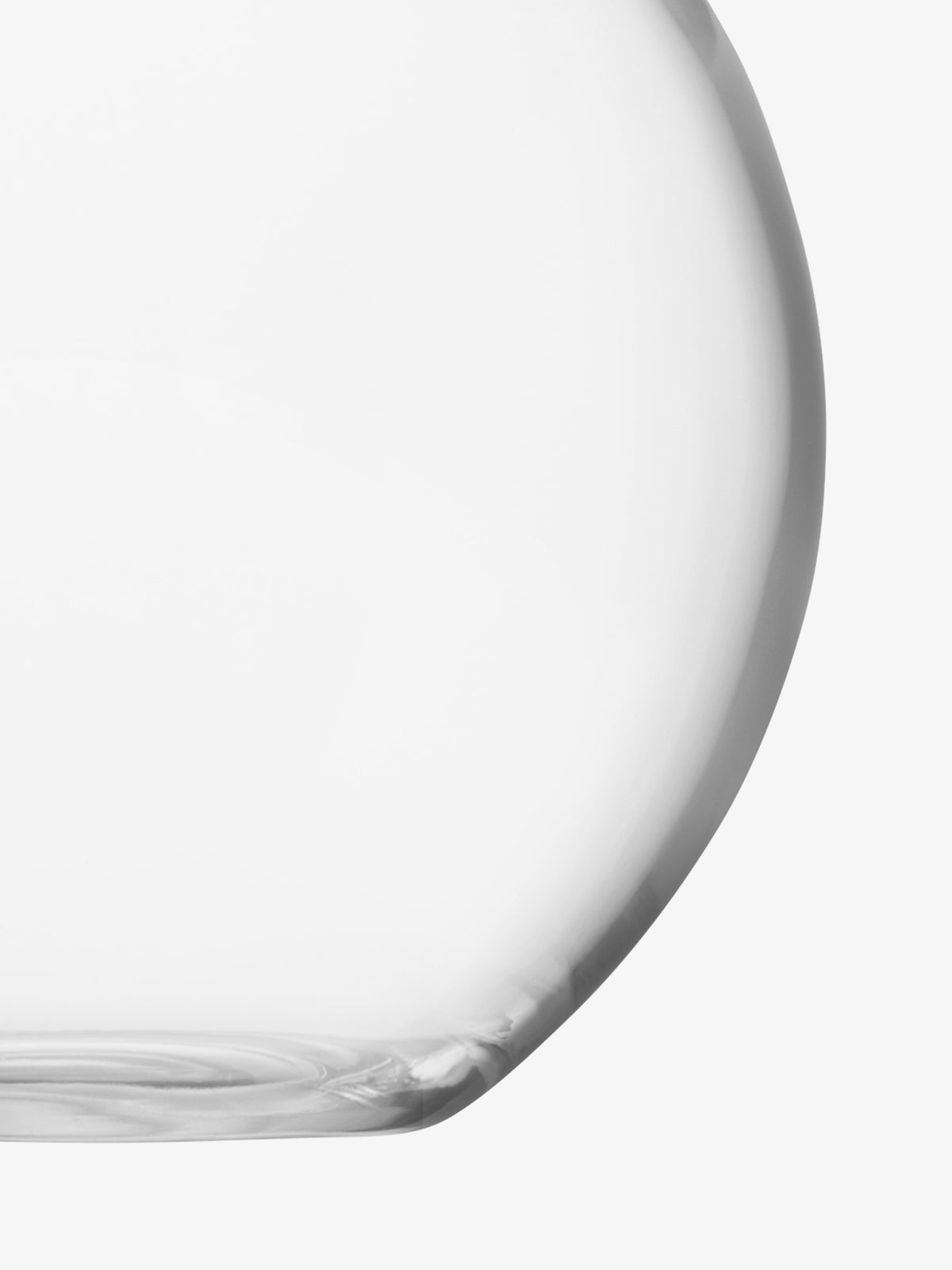 A close-up of the lower half of the lsa-international Bouquet Vase, a clear and rounded glass piece, set against a white background.