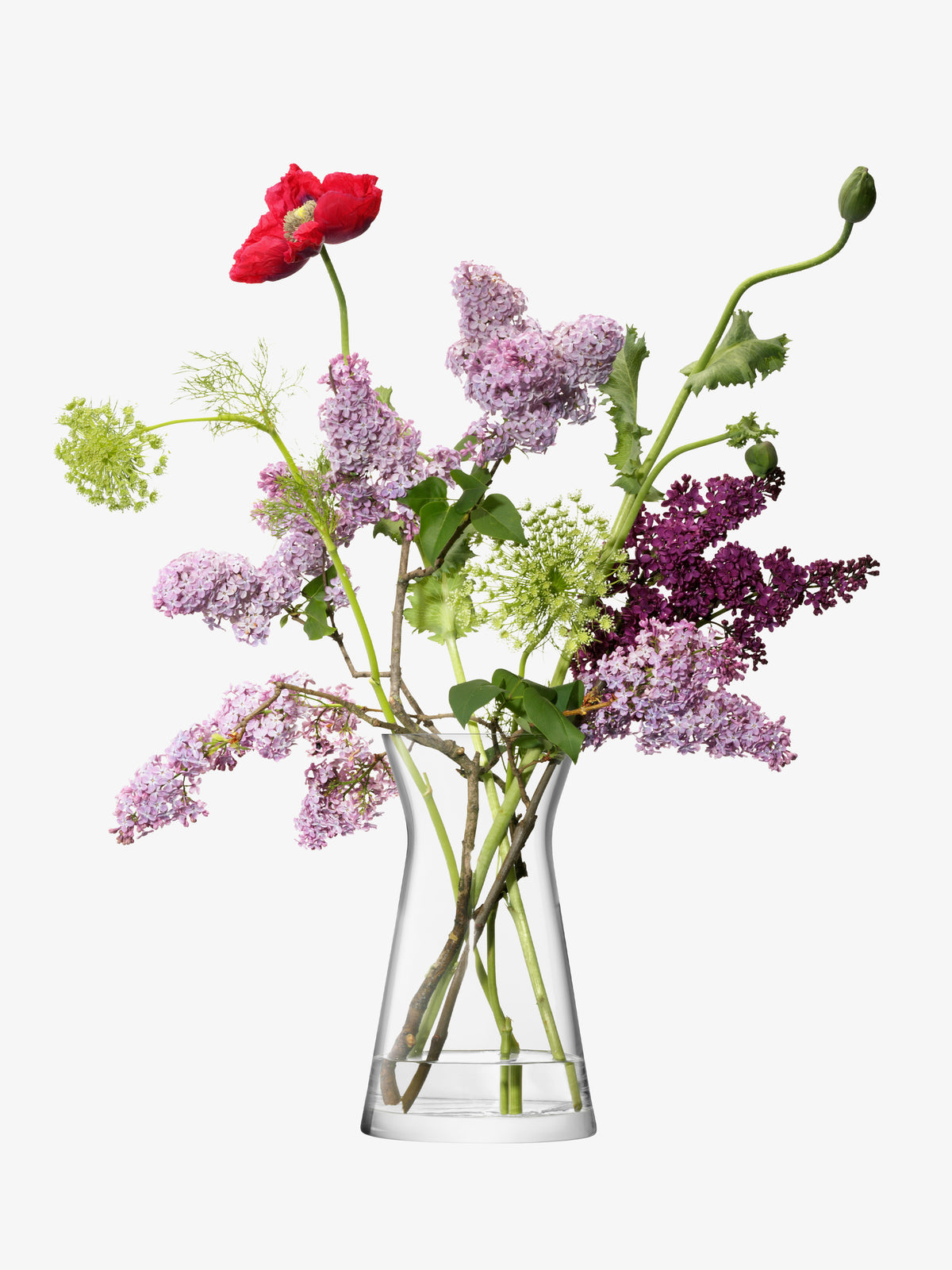 The lsa-international Mixed Bouquet Vase showcases a vibrant arrangement featuring lilac, red poppy, and green foliage. This bouquet displays a blend of purple, red, and green tones with a mix of blooming flowers and buds, all elegantly presented in a clear vase against a white background.