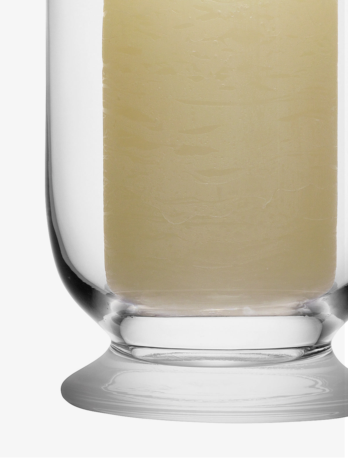 A thick, cream-colored pillar candle inside an LSA International Storm Lantern.