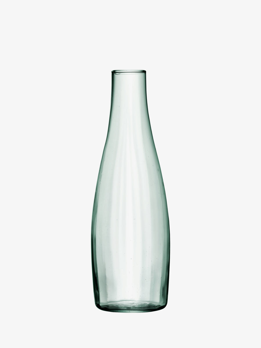 A tall, pale green mouth-blown LSA International Water Carafe with a tapered neck and an empty, carafe-shaped silhouette.