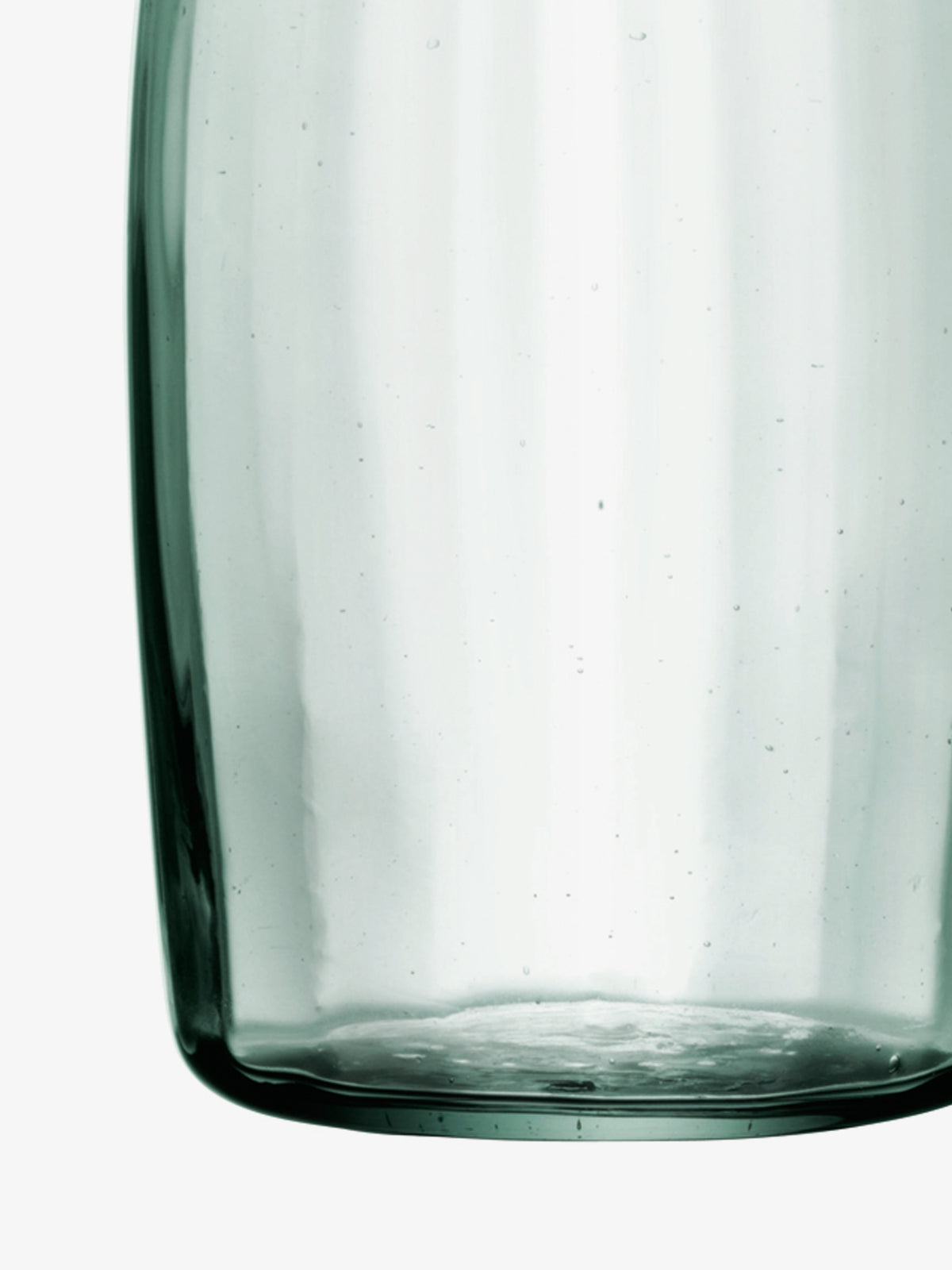 A close-up view of the base of an LSA International Water Carafe made of mouth-blown, light-green glass.