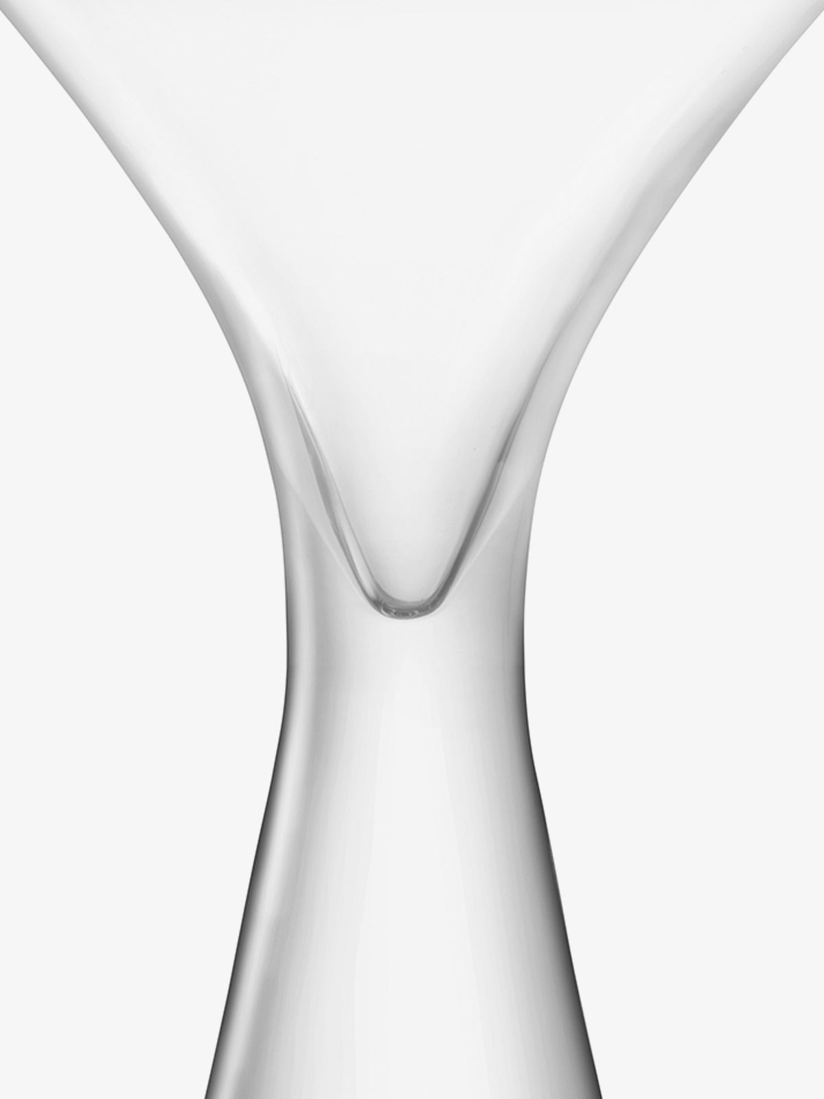 Close-up of the stem and lower bowl of an empty lsa-international Cocktail Glass set against a white background, highlighting the smooth curves and elegant shape of its fine bowl. This piece beautifully showcases craftsmanship reminiscent of traditional mouth-blown cocktail glasses.