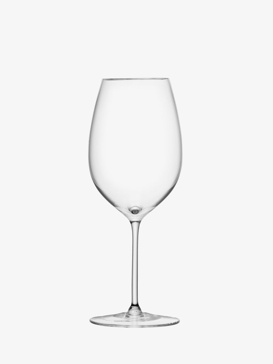 The lsa-international Red Wine Goblet is a clear, empty wine glass with a long stem and wide bowl, reminiscent of classic red wine goblets. Set against a plain white background, this elegant glass showcases mouth-blown craftsmanship and delicately hand-drawn stems for a refined touch.