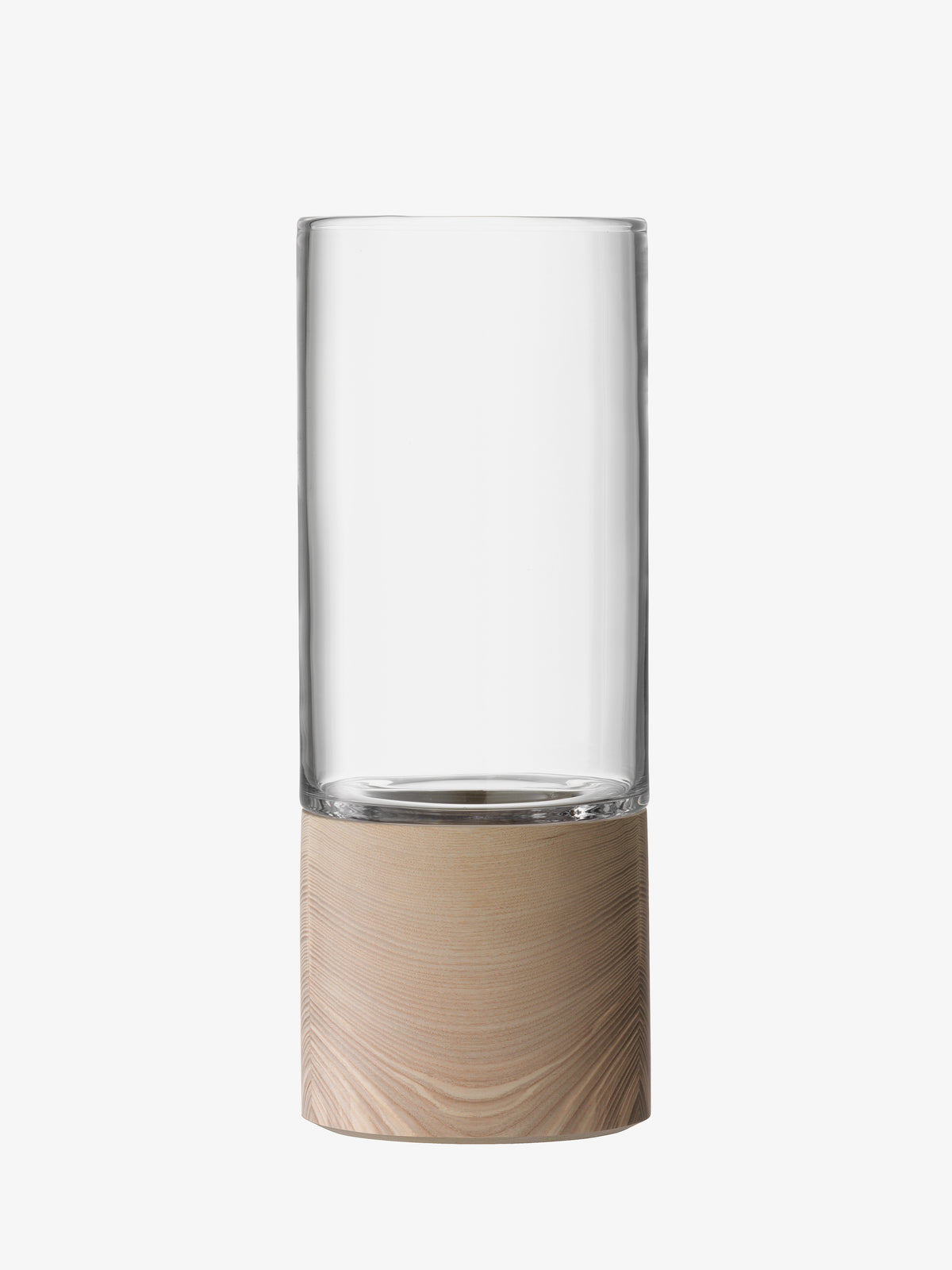 The lsa-international Vase features a clear, cylindrical glass vessel set on a thick, light ash base. Its modern, minimalist design showcases smooth, clean lines and a neutral color palette. Mouth-blown glass adds an artisanal touch to this elegant piece, shown here against a plain white background.