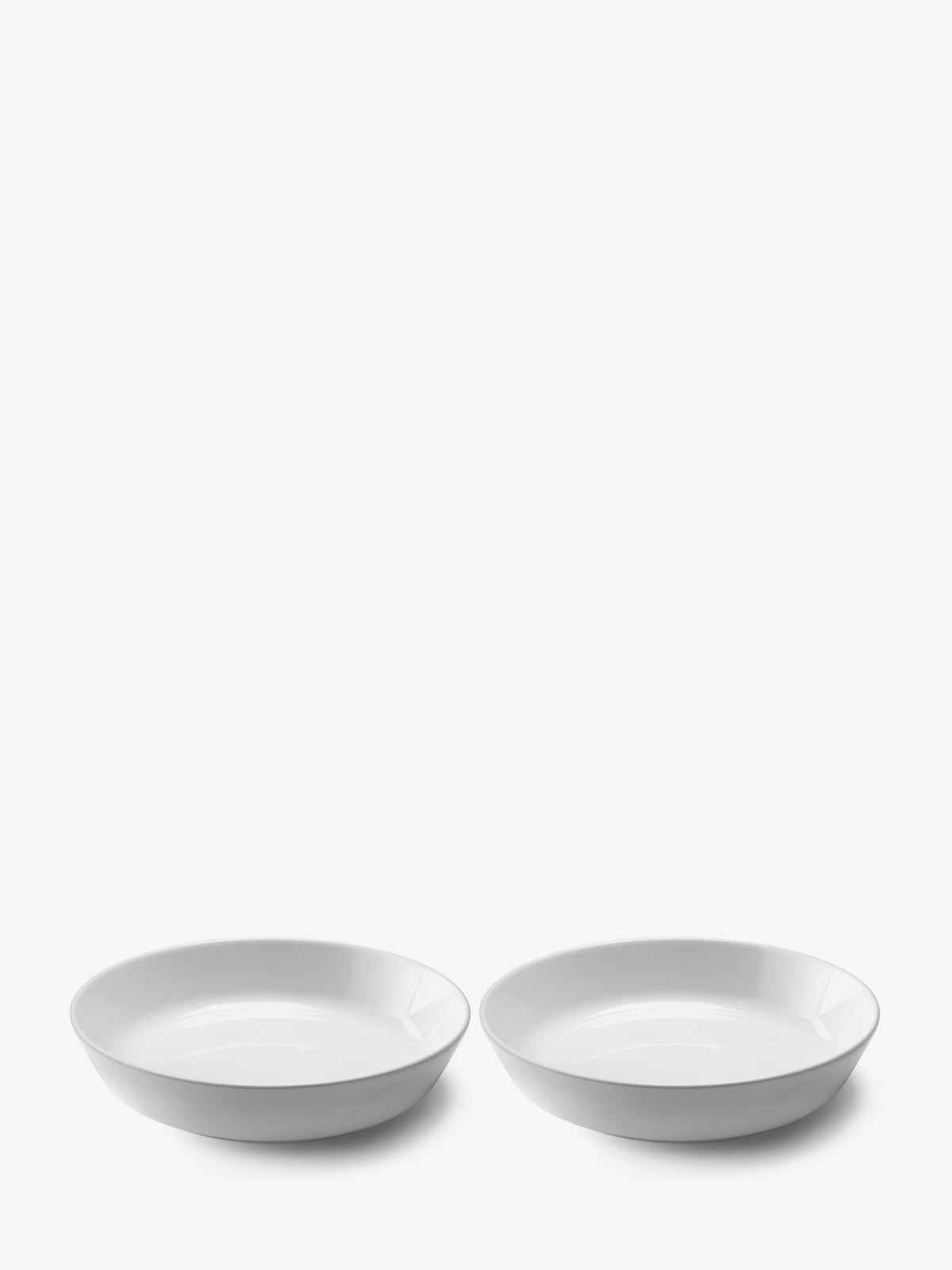 Two wide, shallow porcelain Pasta/Serving Bowl pieces by LSA International sitting side by side.