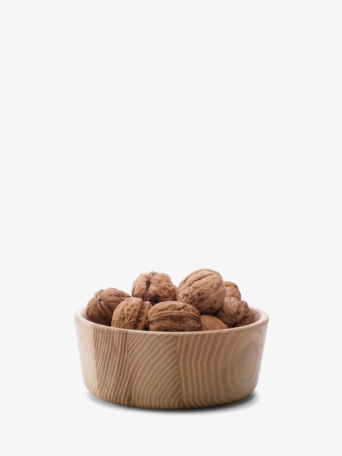 An LSA International Ash Wood Bowl filled with whole walnuts.