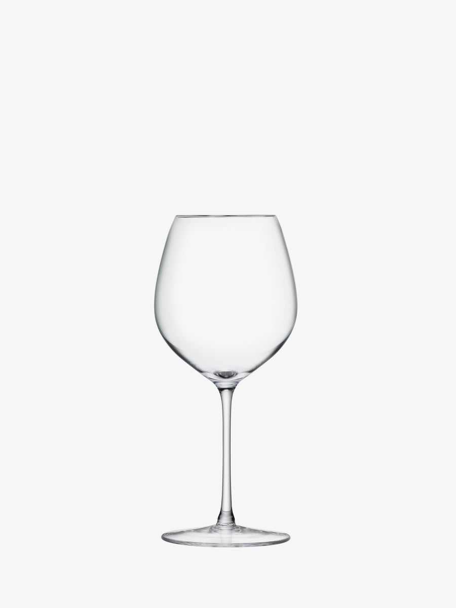 A single, empty lsa-international Red Wine Glass, featuring a clear round bowl and a gracefully hand-drawn long stem reminiscent of elegant red wine glassware, is centered on a plain white background.