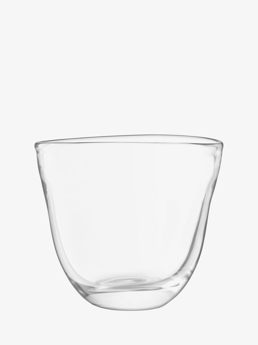 A clear, empty Dual Champagne Bucket by lsa-international with rounded edges and a slightly irregular shape—crafted from hand blown glass—set against a plain white background.