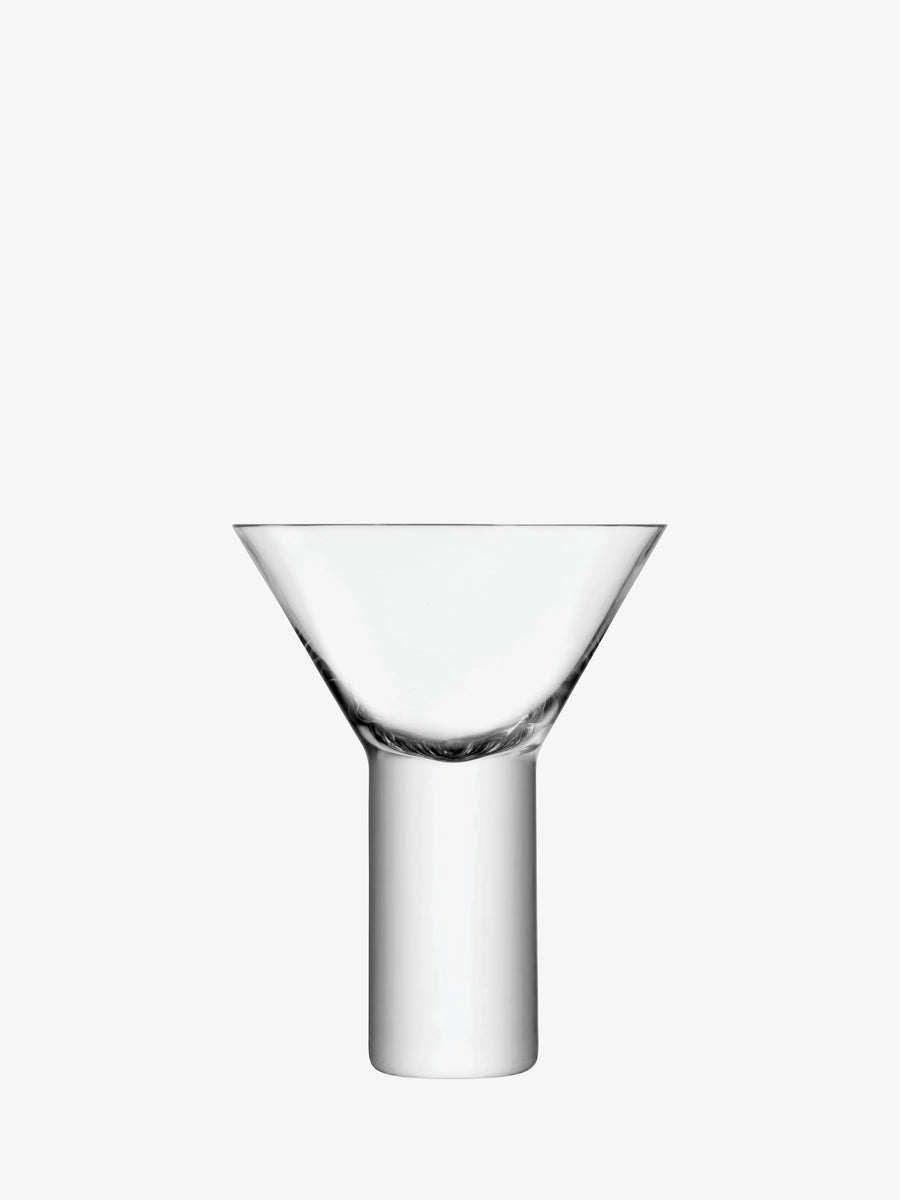 The lsa-international Cocktail Glass, photographed against a plain white background, features a clear glass vessel with a cylindrical base and a wide, flared bowl on top, exemplifying the modern shapes of mouth-blown cocktail glasses while drawing inspiration from classic forms.