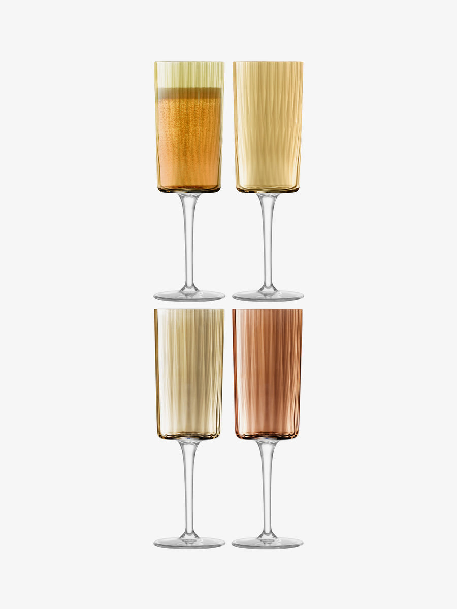 Four Champagne Flute glasses by lsa-international, each showcasing a unique ribbed texture in tones of amber, gold, and brown, are arranged in a two-by-two grid on a white background. These elegant hand-painted glasses bring sophisticated style to any setting with their refined, textured design.