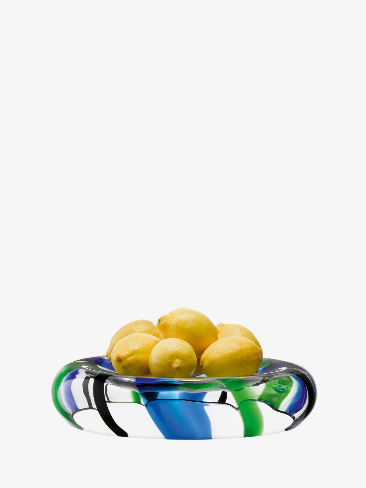 Six yellow lemons rest in the lsa-international Bowl, a clear mouth-blown glass piece featuring swirling blue and green patterns, set against a white background.