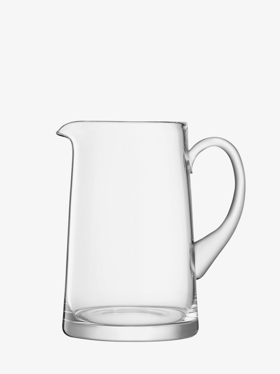 The Tapered Jug by lsa-international features clear glass with a curved handle and a small spout, hand-formed and photographed against a plain white background.