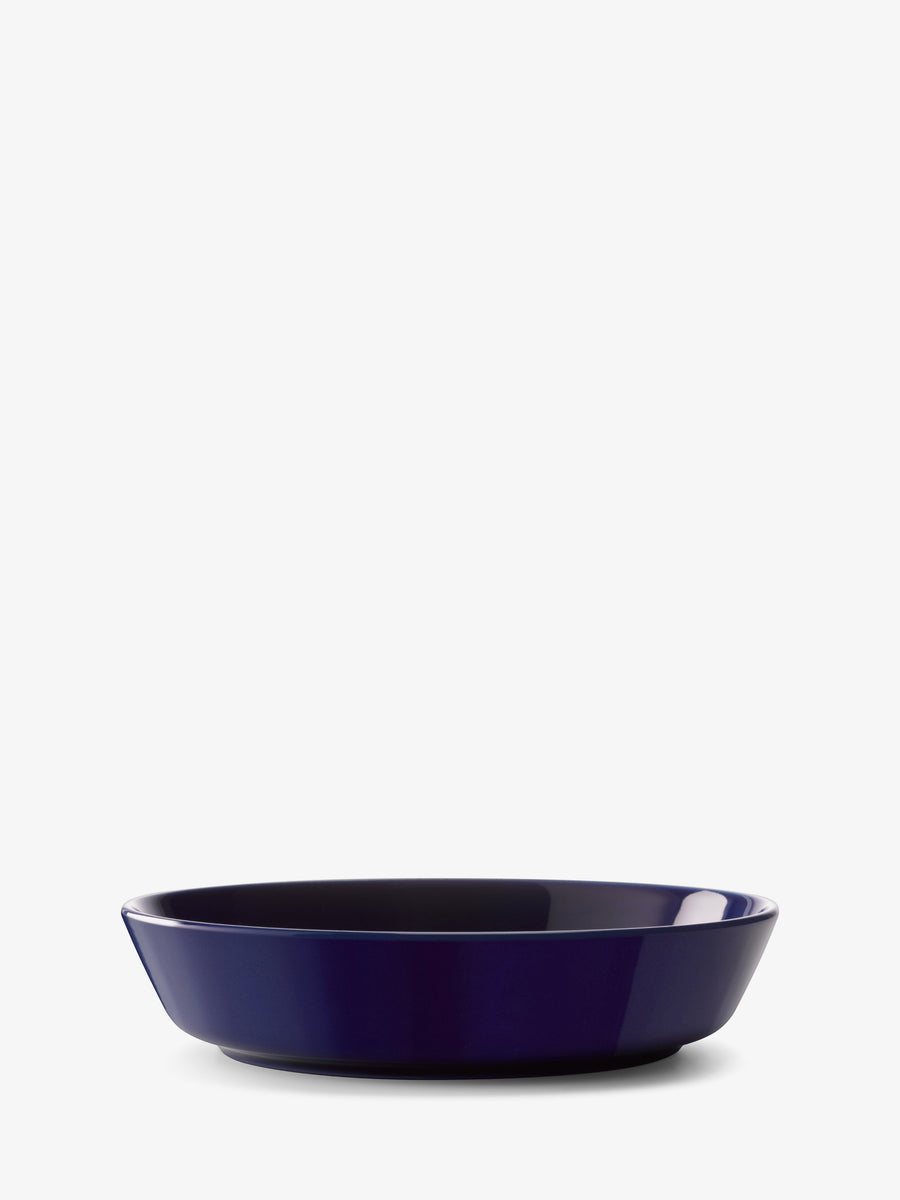 A deep, round lsa-international Starter/Pasta Bowl in dark blue ceramic sits centered on a white background under even lighting, its minimalist design exemplifying contemporary tableware crafted to complement modern porcelain bowls and settings.